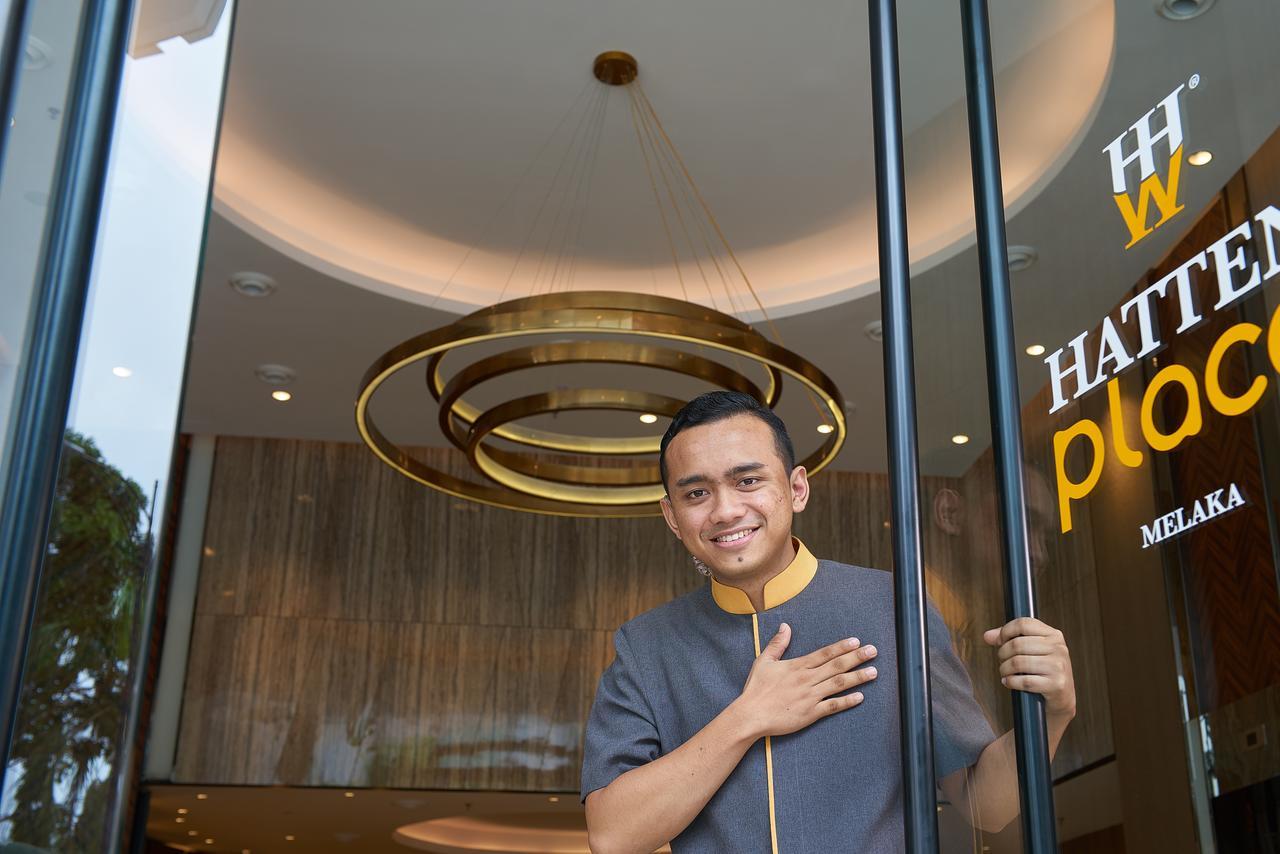 Hatten Place Melaka Экстерьер фото A doorman at the entrance of a hotel in Malaysia.